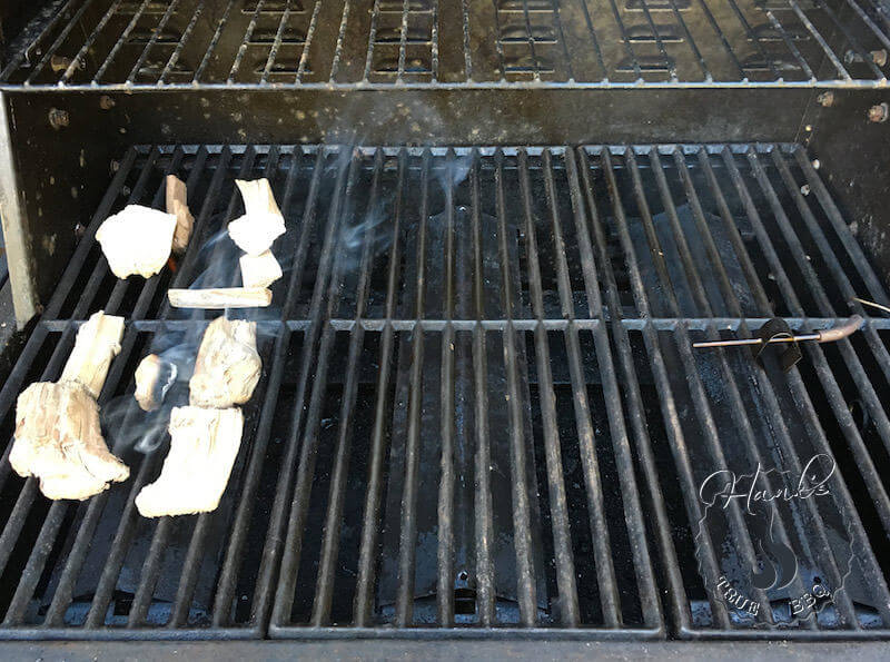 Wood chunks on gas grill, just about to start smouldering.
